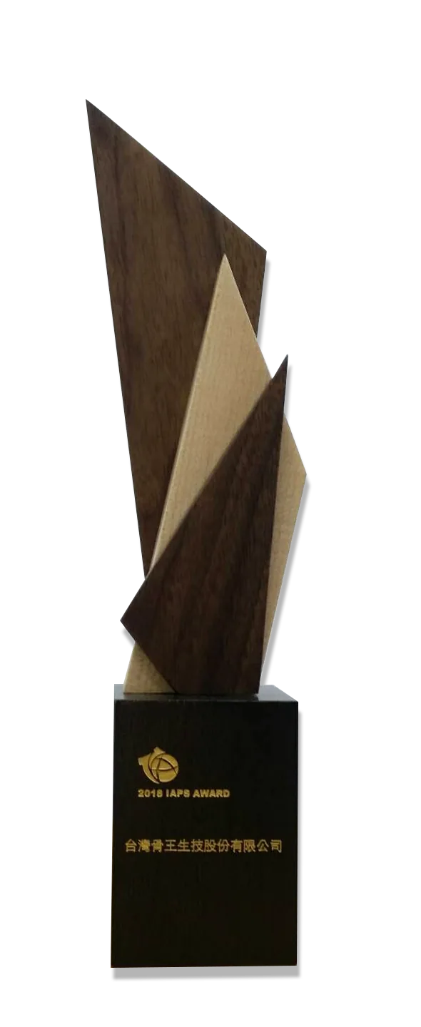 A tall two-tone wooden trophy on a black base, engraved 2018 IAPS Award.