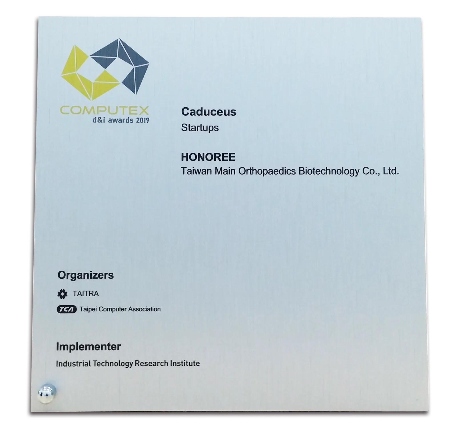 A brushed metal COMPUTEX d and i awards 2019 plaque naming Caduceus in
                    the Startups category.