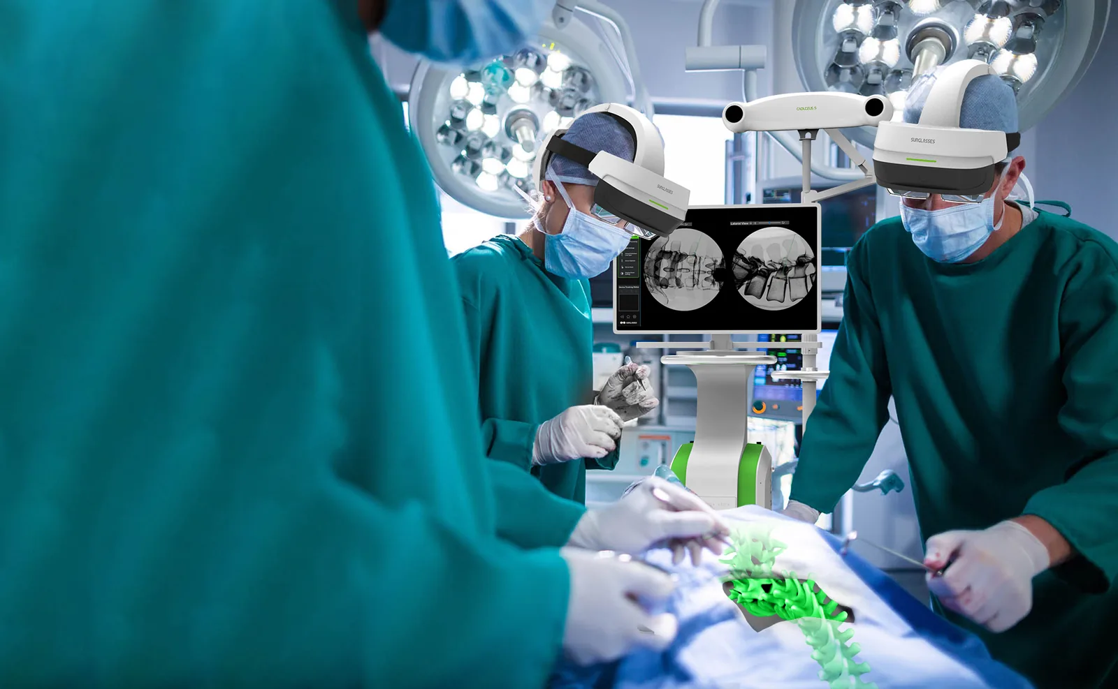 Two surgeons in green gowns and Caduceus S headsets operating in a hospital
                  theatre. The Caduceus S tracking camera and its touchscreen stand between
                  them showing two fluoroscopy views, and a green 3D model of the spine lies
                  along the draped patient.